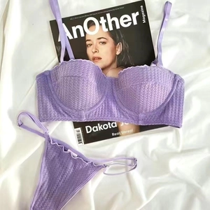 Detail of purple lace lingerie set on silk fabric with 1/2 cup bra and matching panties