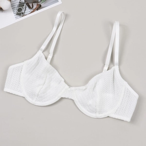 Close-up of white mesh lace texture with underwire support and elegant adjustable straps