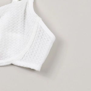 Detail shot of white lace lingerie featuring breathable mesh fabric and fine stitching