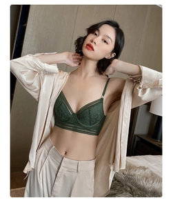 Detail of dark green lace bra paired with a silk shirt for a stylish interior look
