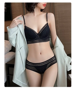 Detailed view of black lace lingerie set with stripe details and sheer mesh fabric