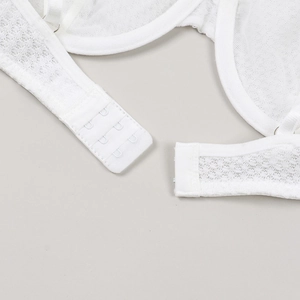 Detail of white mesh lace bra featuring adjustable three-row back hook and eye closure