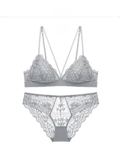 Flat lay of gray French lace triangle bra and matching panties with floral patterns