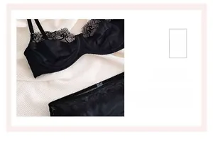 Detailed close-up of delicate eyelash lace trim and satin fabric on black lingerie set