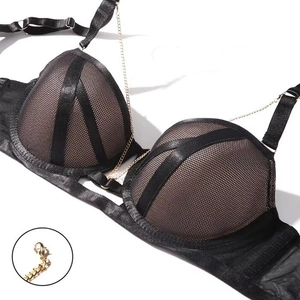 Close-up of black mesh lingerie with satin trim and golden metal chain details