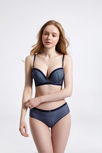 Detailed macro view of navy blue grid mesh lingerie set with golden hardware accents