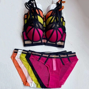 Detailed close-up of colorful lace lingerie sets with contrasting straps and JC charms
