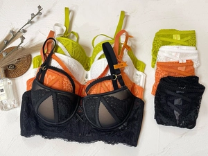 Flat lay of lace lingerie set with push-up bras and matching panties in four colors