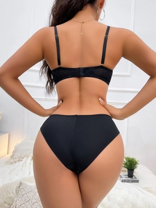 Rear view of black lace lingerie set featuring smooth fabric and high-waisted briefs