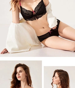 Detail view of black eyelash lace lingerie set featuring pink bows and sheer floral patterns