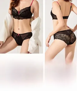 Detail of ultra-thin black lace bra set with pink straps and sheer panty on model