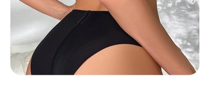 Detail view of high waist black ribbed fabric texture for seamless lifting underwear