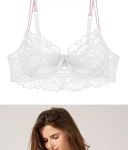 Detail of white floral lace bra with pink bow accent and breathable sheer mesh fabric