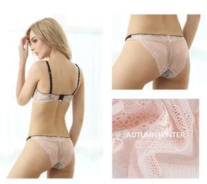 Detail of pink floral lace lingerie set with thin black straps and sheer fabric texture