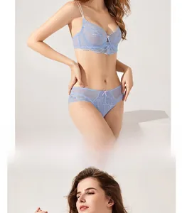 Detailed close-up of light blue floral lace bra and panty set with small pink bow