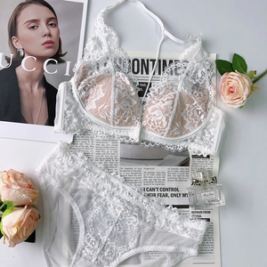 Flat lay of white floral lace lingerie set with triangle bra and sheer lace panties