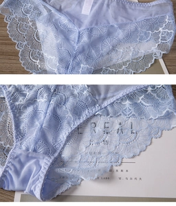Detail of light blue floral lace underwear with scalloped edges on a rustic wood background