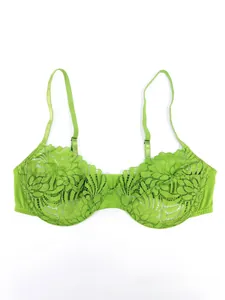Detailed close-up of light green floral lace embroidery on a thin soft cup bra
