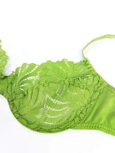 Detail shot of bright green floral embroidery lace and scalloped edges on the bra cup