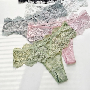 Detailed view of lace thongs with criss-cross waist and delicate eyelash floral trim