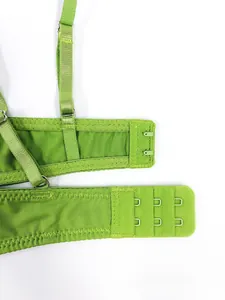 Detail of adjustable double hook-and-eye back closure on green lace lingerie set