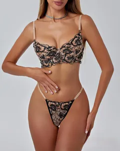 Detailed embroidery of floral black lace on a beige mesh two-piece lingerie set