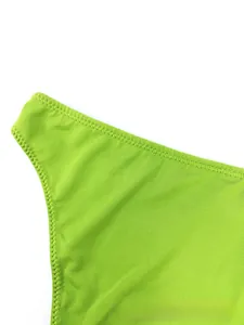 Detailed macro view of bright green lace lingerie featuring fine vertical textures