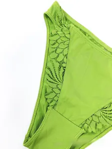 Detailed close-up of grass green lace stitching and smooth fabric on these panties