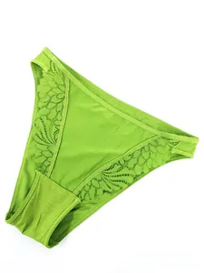 Detailed view of bright green lace panties with floral embroidery and mesh panels