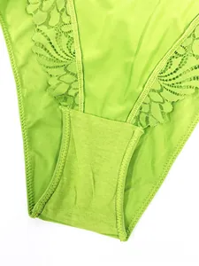 Close-up of neon green lace detailing and high-quality cotton fabric on women's lingerie