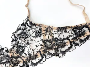 Detail of black floral embroidery on sheer mesh with adjustable shoulder straps