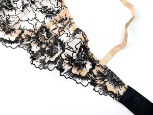 Detail of floral lace embroidery and back hook closure on a mesh lingerie set