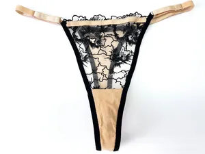 Detail of floral lace thong with adjustable metal buckles and contrast paneling