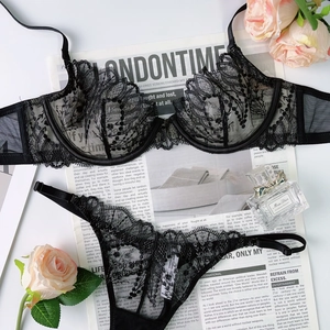 Flat lay of black lace lingerie set with scalloped edges on a stylish background