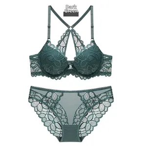 Detail of dark green lace lingerie set with front closure bra and crisscross straps
