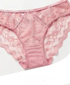 Dettaglio ravvicinato di slip in pizzo rosa con spalline a V e finiture in pizzo ciglia