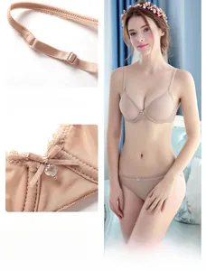Detail of nude lace lingerie set showing non-slip straps and heart pendant charm decoration