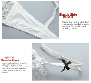 Detail of white lace bra featuring elastic side wings and adjustable straps with bows