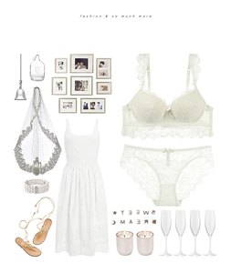 Flat lay of white lace lingerie set with matching hollow out dress and wedding veil