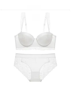 Flat lay of a white floral lace lingerie set featuring a 1/2 cup wired bra and brief