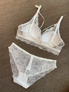 Flat lay of white French lace lingerie set featuring a soft cup bra and matching panties