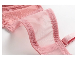 Detailed macro view of pink breathable lace embroidery and mesh fabric with soft straps