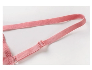 Detail of pink elastic bra strap with adjustment buckle and delicate mesh fabric texture
