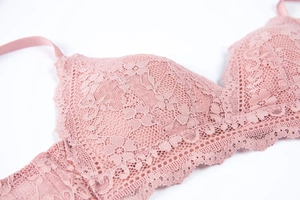 Detailed view of delicate dusty pink floral lace texture on a wireless triangle bra cup