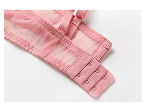 Macro detail of the adjustable three-row back closure and breathable pink mesh lace