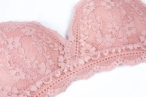 Close-up of pink French floral lace fabric with delicate eyelash trim on triangle cups