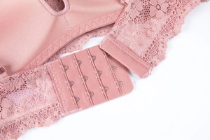 Close-up of pink lace bra featuring a four-row hook-and-eye closure and breathable mesh