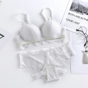 Flat lay of white lace triangle bralette and matching panties on a stylized background