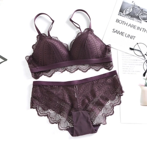 Flat lay of deep purple lace lingerie set with wireless bra and matching panties on white
