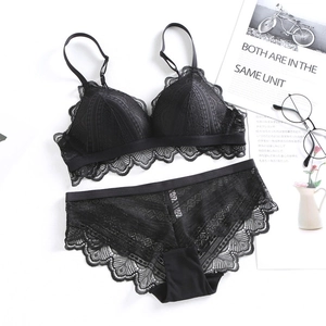 Detailed flat lay of a black lace bra and panty set with delicate floral patterns